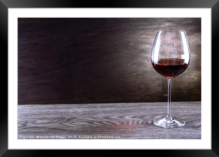 Single Wineglass on a wooden Table Framed Mounted Print by Guido von Oepen