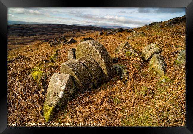 Abandoned Mill Stones under Stanage Edge. Framed Print by Chris Drabble