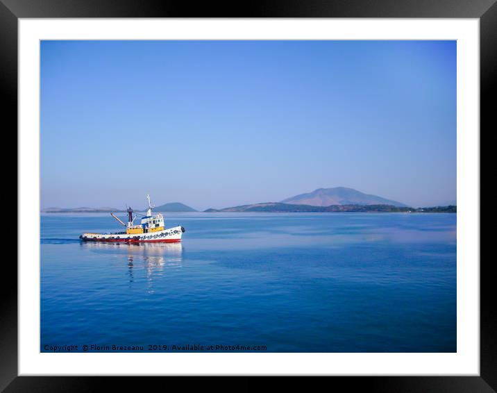 small colorful fishing boat in calm water  Framed Mounted Print by Florin Brezeanu