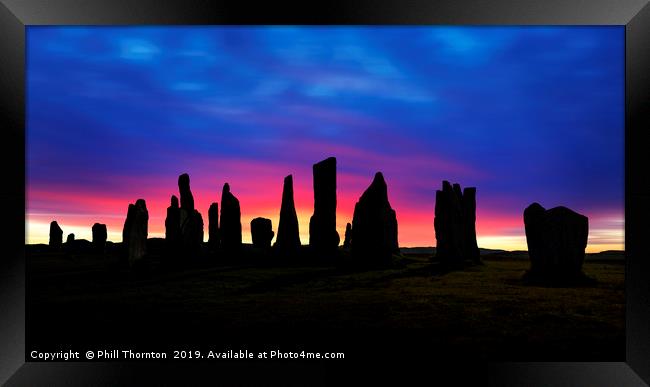 Sunset over the  Callanish Standing Stones Framed Print by Phill Thornton