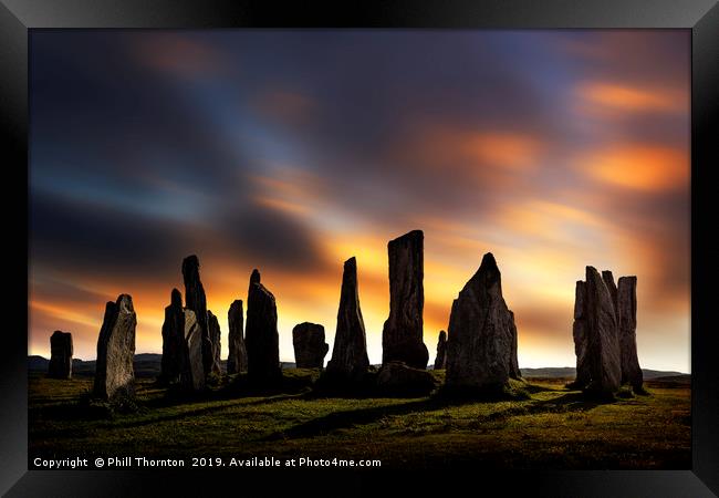 Sunset over the  Callanish Standing Stones Framed Print by Phill Thornton