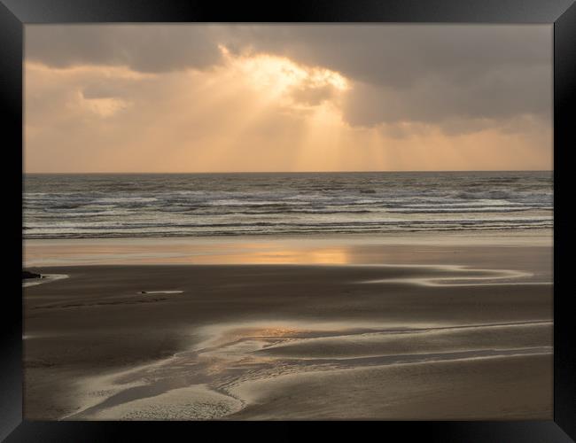 Ray of sunlight through the clouds at Westward Ho! Framed Print by Tony Twyman