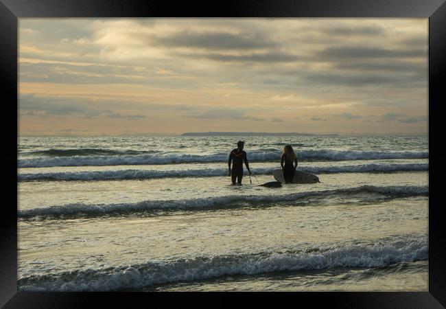 Sunset surfers at Westward Ho! in Devon Framed Print by Tony Twyman