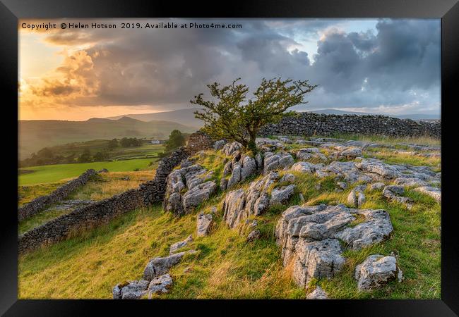 Stormy sunset over a small limestone pavement Framed Print by Helen Hotson