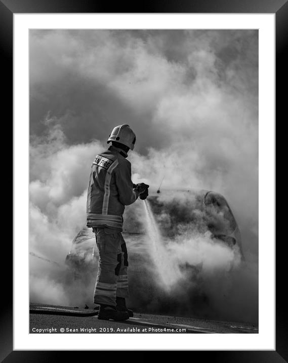 Fireman Tackles a Car Fire Framed Mounted Print by Sean Wright