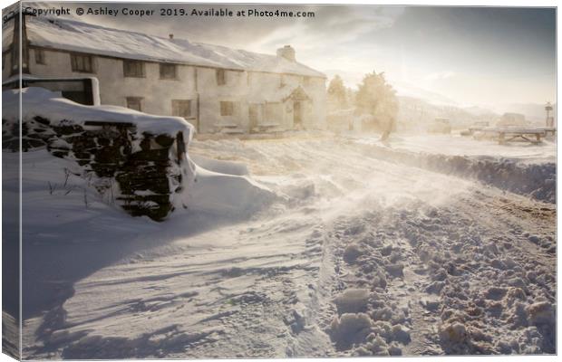 The Kirkstone Pass Inn, plastered in fresh snow  Canvas Print by Ashley Cooper