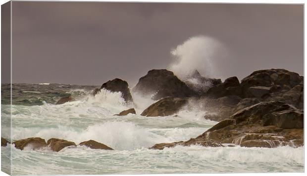 Stormy waves crashing against the rocks Canvas Print by Steve Mantell