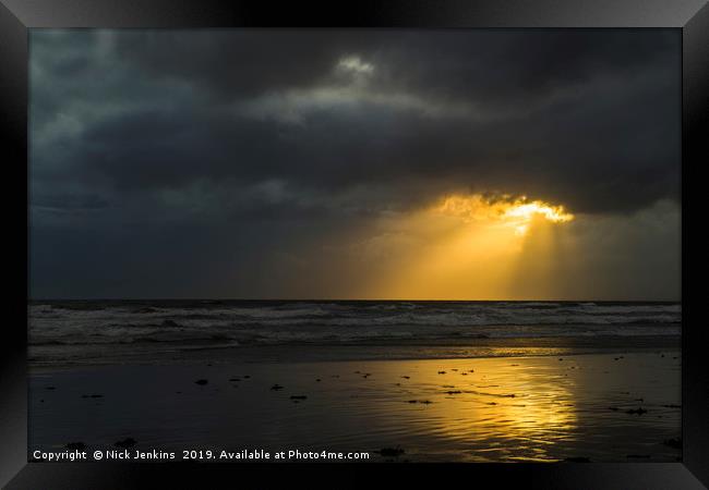 Sunlight through Dark Cloud South Wales coast Framed Print by Nick Jenkins