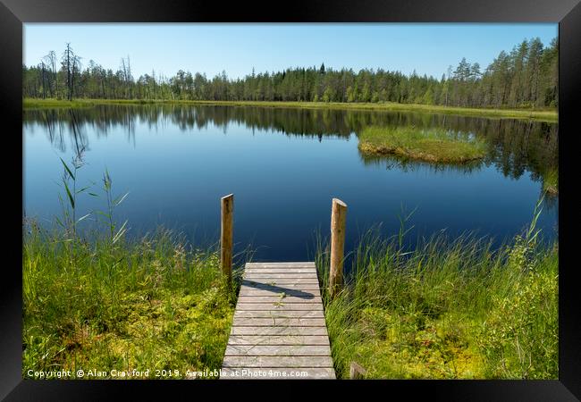 Jetty by a lake in Finland Framed Print by Alan Crawford