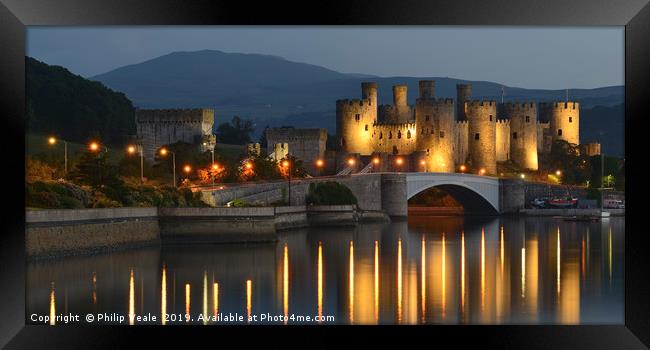 Conwy Castle's Dusk Illumination Framed Print by Philip Veale