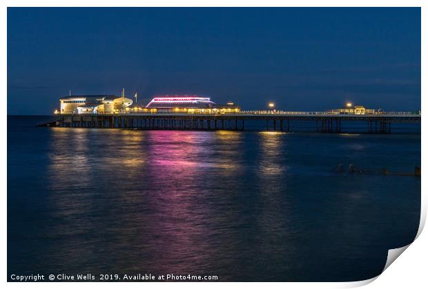Cromer Pier at night in North Norfolk Print by Clive Wells