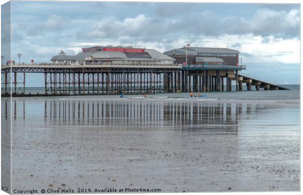 Reflections of Cromer Pier in Norfolk Canvas Print by Clive Wells