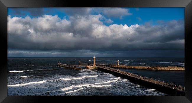Stormy Skies over Whitby Pier Framed Print by Dan Ward