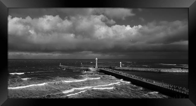 Stormy Skies over Whitby Pier  Framed Print by Dan Ward
