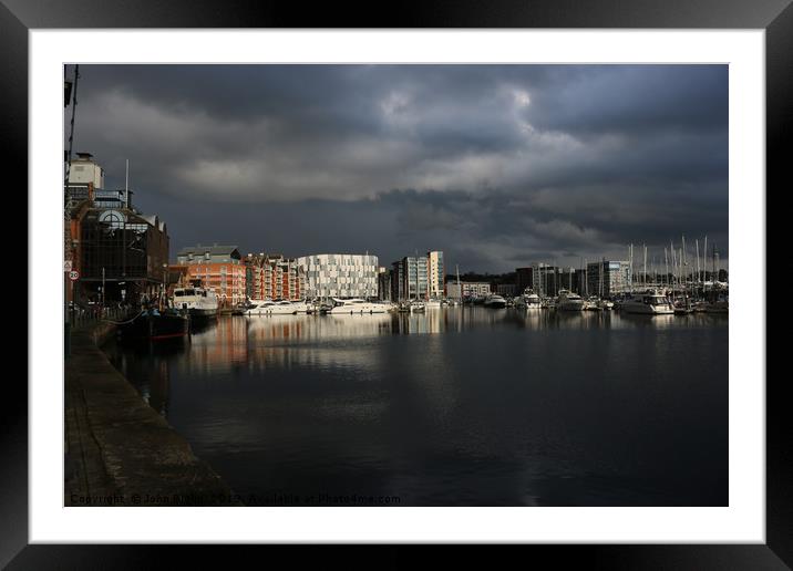 Ipswich waterfront marina with storm clouds Framed Mounted Print by John Biglin