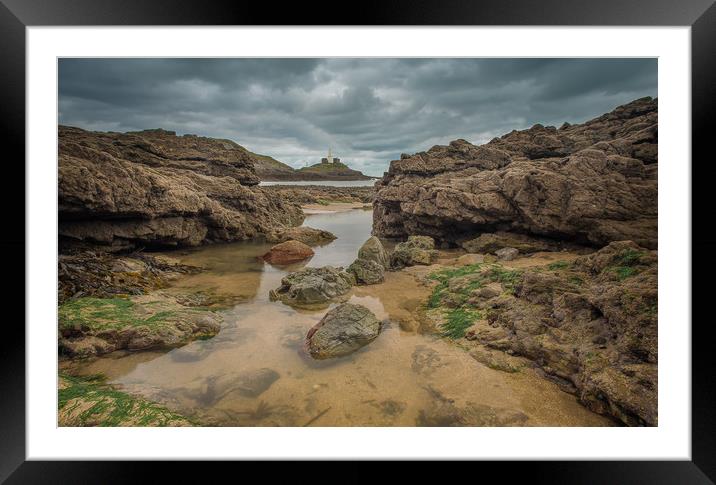 Mumbles lighthouse viewed from a rock pool. Framed Mounted Print by Bryn Morgan