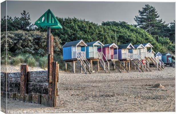 Beach huts and marker at Wells next the Sea, Norfo Canvas Print by Sally Lloyd