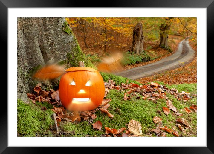 Halloween pumpkin in autumn woodland Framed Mounted Print by Simon Bratt LRPS
