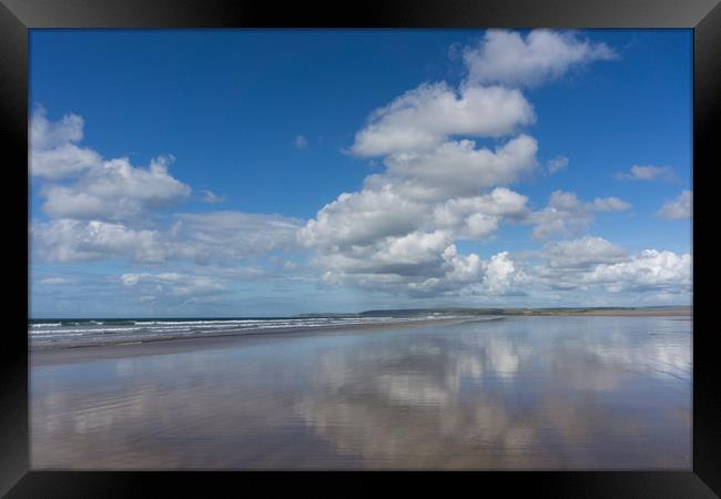 Clouds reflecting on a deserted Westward Ho beach Framed Print by Tony Twyman