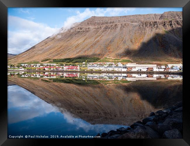 Isafjordur town in Iceland reflecting in the fjord Framed Print by Paul Nicholas
