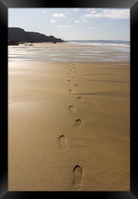Footsteps on a deserted Cornish beach Framed Print by Tony Twyman