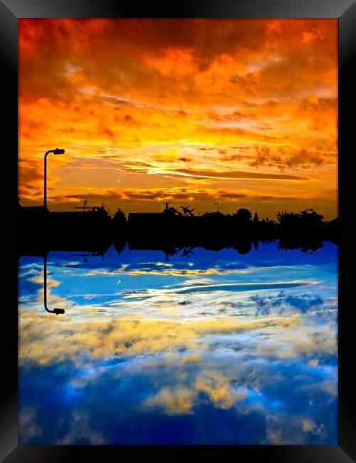 Abstract sunrise / sunset over silhouette village Framed Print by Paul Cooper