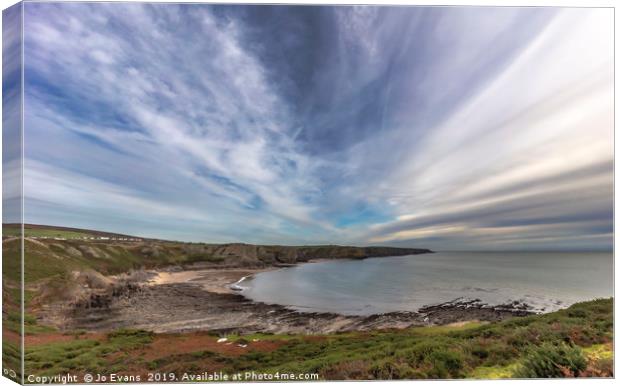 Clouds over Fall Bay, Gower Canvas Print by Jo Evans
