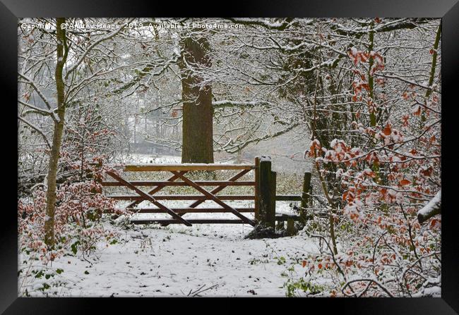 Winterly scene with snowy gate and style. Framed Print by Andrew Heaps