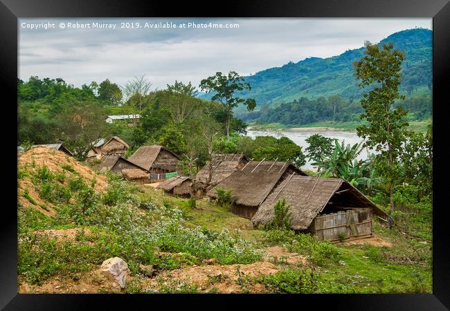 Tribal Village on the Mekong, Laos. Framed Print by Robert Murray