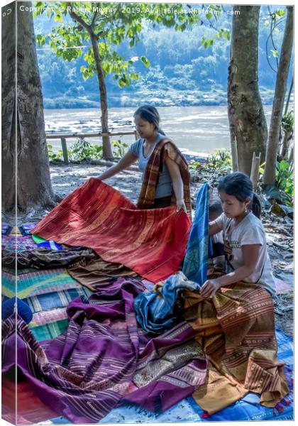 Preparing cloth for market, Laos. Canvas Print by Robert Murray