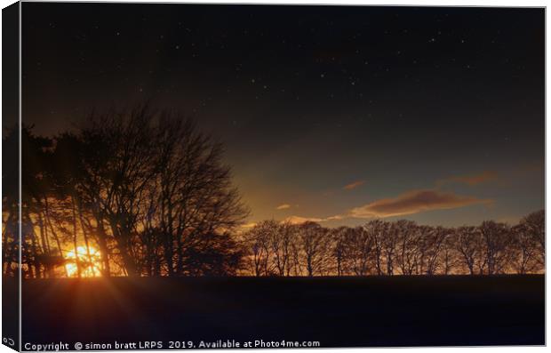 Big sunset glow through winter trees Canvas Print by Simon Bratt LRPS