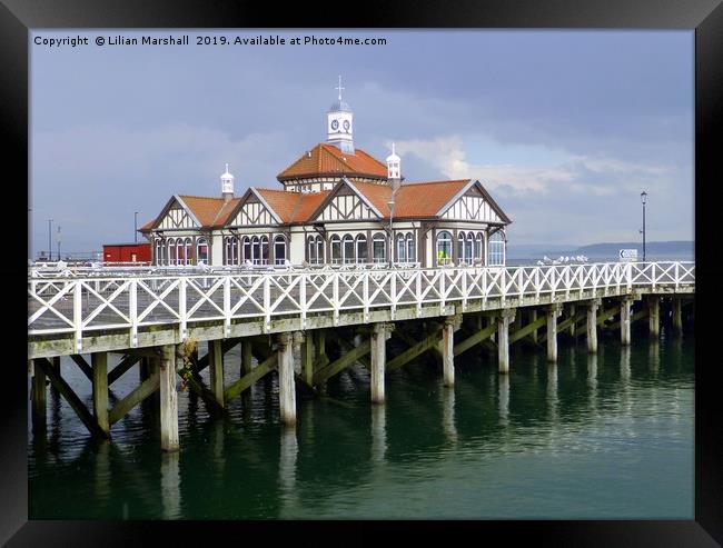 Grey skies over Dunoon Pier. Scotland. Framed Print by Lilian Marshall