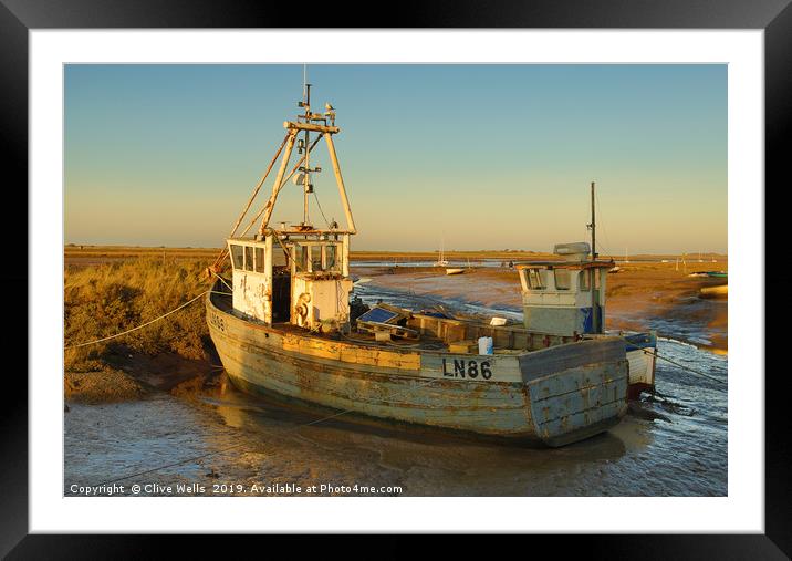 Fishing boat grounded at Brancaster Staith Framed Mounted Print by Clive Wells