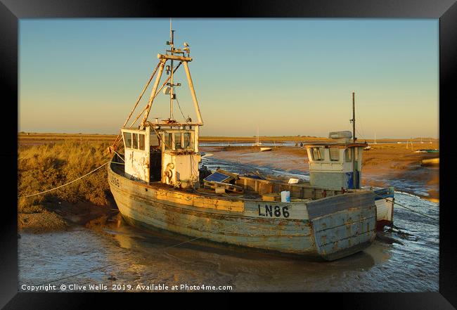 Fishing boat grounded at Brancaster Staith Framed Print by Clive Wells
