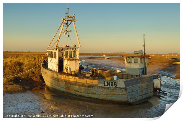 Fishing boat grounded at Brancaster Staith Print by Clive Wells