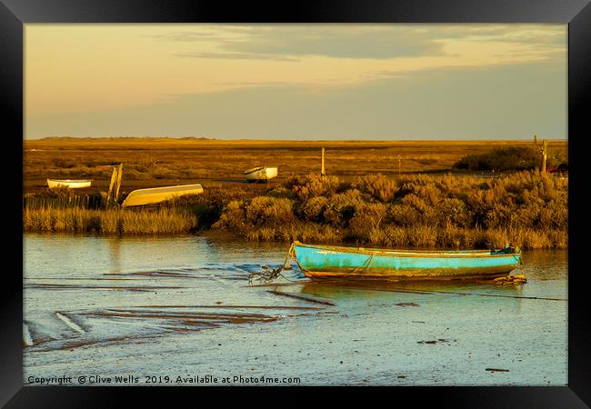 Row boat at Brancaster Staith in North Norfolk Framed Print by Clive Wells