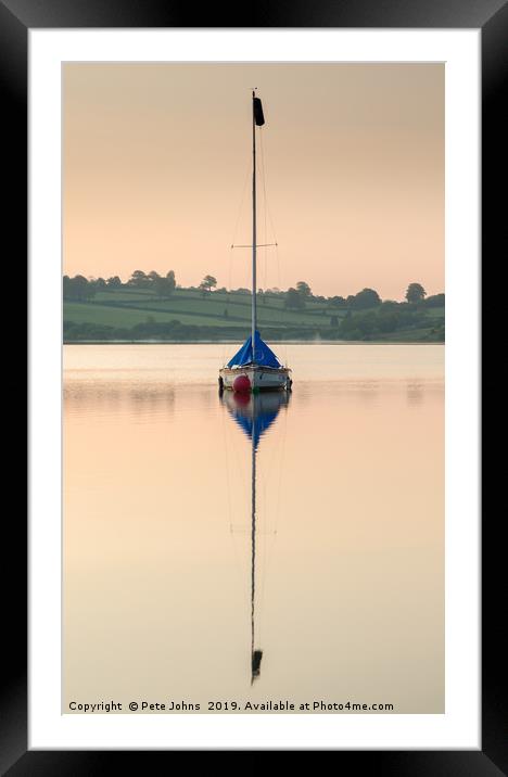 Boat reflecting on lake Framed Mounted Print by Pete Johns