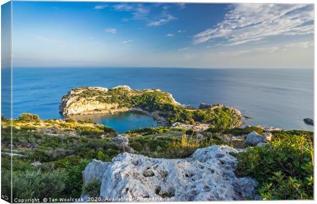 Overlooking Anthony Quinn Bay Rhodes Canvas Print by Ian Woolcock