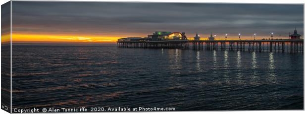 Sunset over the pier Canvas Print by Alan Tunnicliffe