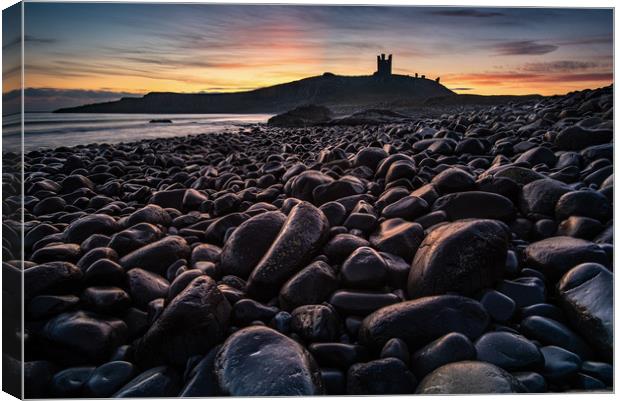 First light on the rocks at Dunstanburgh Castle Canvas Print by George Robertson