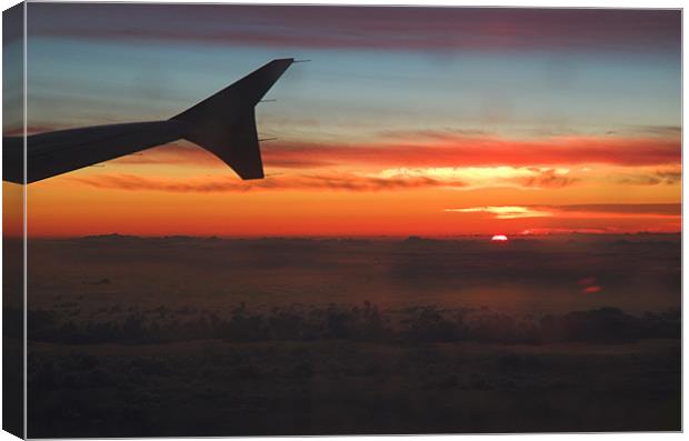 A Sunset from the porthole of a plane I was flying Canvas Print by JEAN FITZHUGH