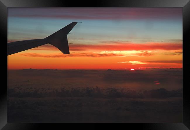 A Sunset from the porthole of a plane I was flying Framed Print by JEAN FITZHUGH