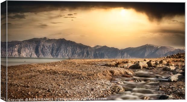 Wild beach over mountains and dramatic sky. Canvas Print by RUBEN RAMOS