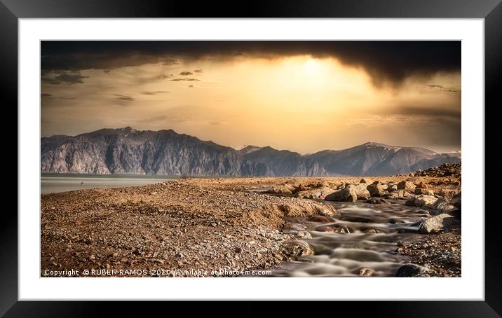 Wild beach over mountains and dramatic sky. Framed Mounted Print by RUBEN RAMOS