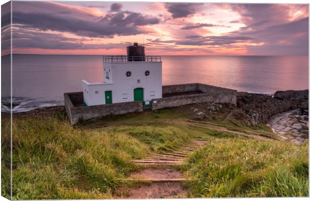 Bamburgh Lighthouse at sunrise Canvas Print by Marcia Reay