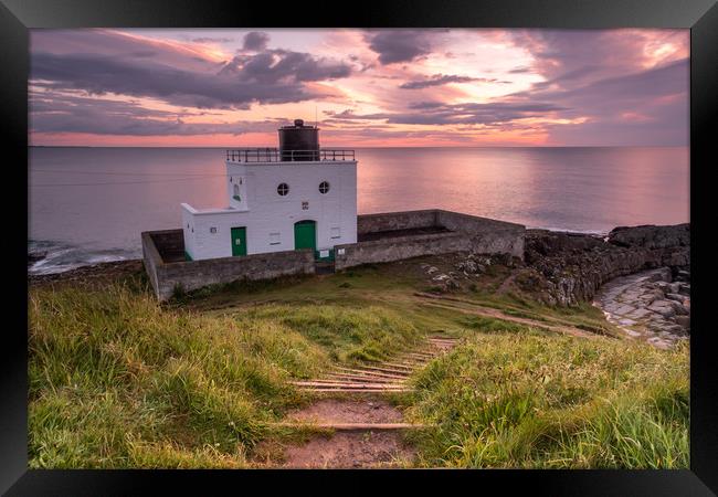 Bamburgh Lighthouse at sunrise Framed Print by Marcia Reay