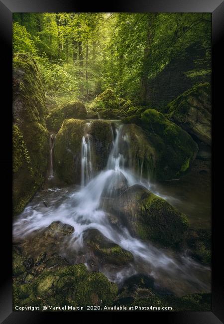 Waterfall in a fairytale-like forest Framed Print by Manuel Martin