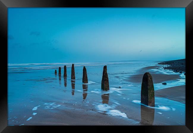 Weathered beach groynes at Dawn Framed Print by Tony Twyman