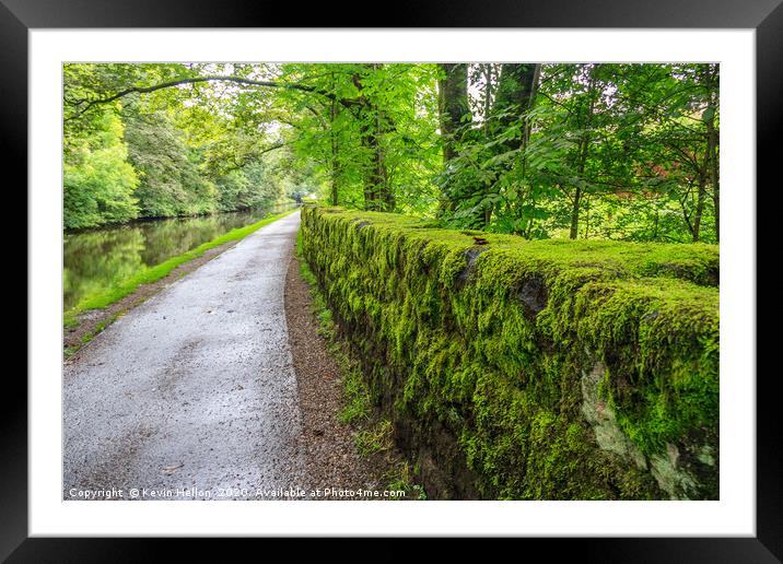 Towpath and green moss growing on stone wall Framed Mounted Print by Kevin Hellon