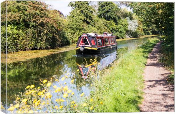 A narrowboat makes its way along the Grand Union c Canvas Print by Kevin Hellon